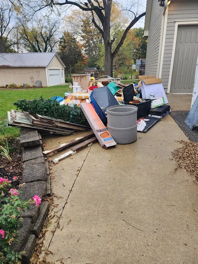 Dumpster being loaded with debris for Roofing Dumpster Rental in Thomaston